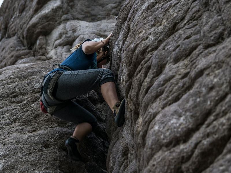 Athletic person doing mountain climbers on a dark background