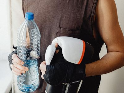 Person hands holding a water bottle after intensive workout